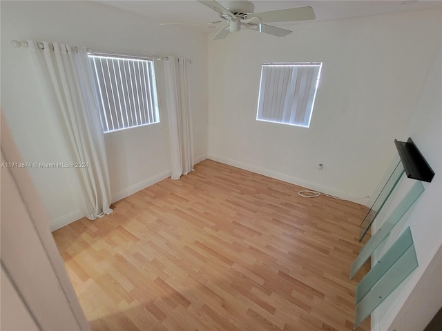 empty room featuring light wood-type flooring and ceiling fan