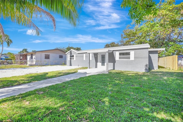 ranch-style house featuring a front lawn