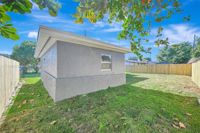 view of side of home with a yard