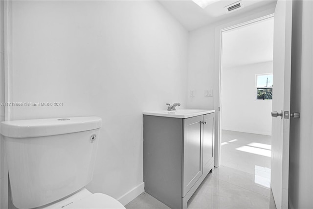 bathroom featuring tile patterned floors, vanity, and toilet