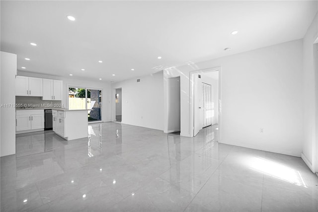 kitchen with dishwasher, a kitchen island, decorative backsplash, and white cabinetry