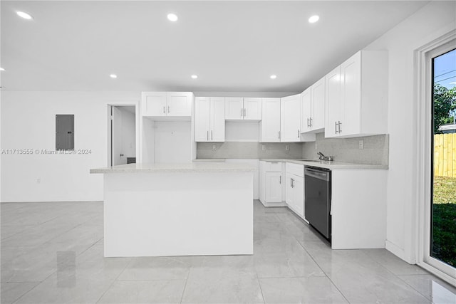 kitchen with stainless steel dishwasher, a center island, white cabinetry, and electric panel