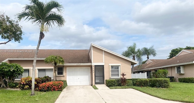 ranch-style house with a garage and a front lawn