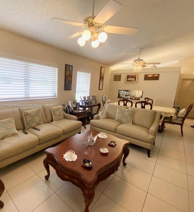 tiled living room featuring a textured ceiling and ceiling fan