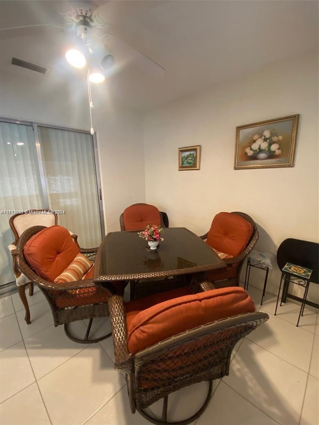 living area featuring ceiling fan and tile patterned flooring