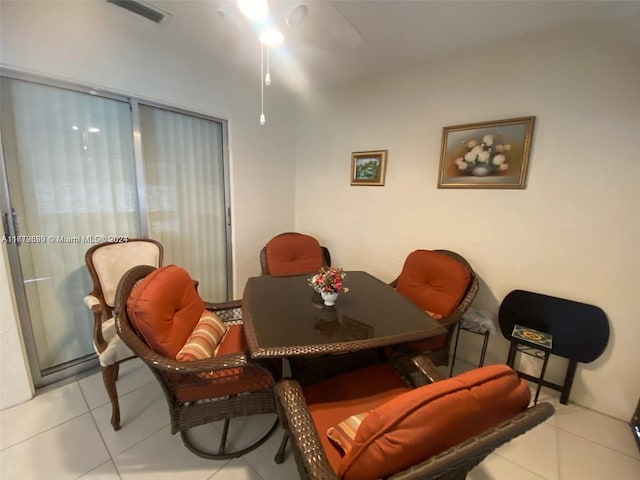 tiled dining space with ceiling fan