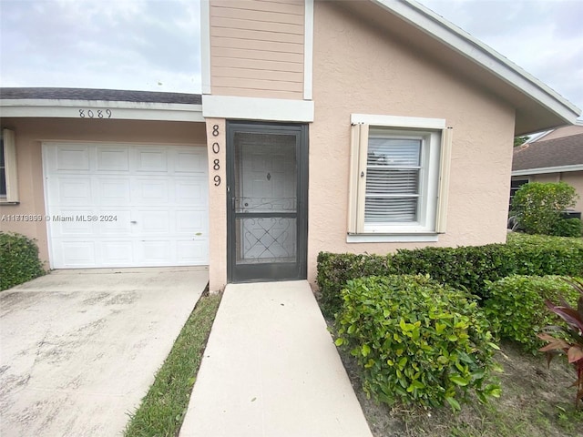 doorway to property featuring a garage