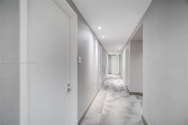 hallway with light colored carpet