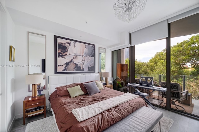 bedroom with light wood-type flooring and a chandelier