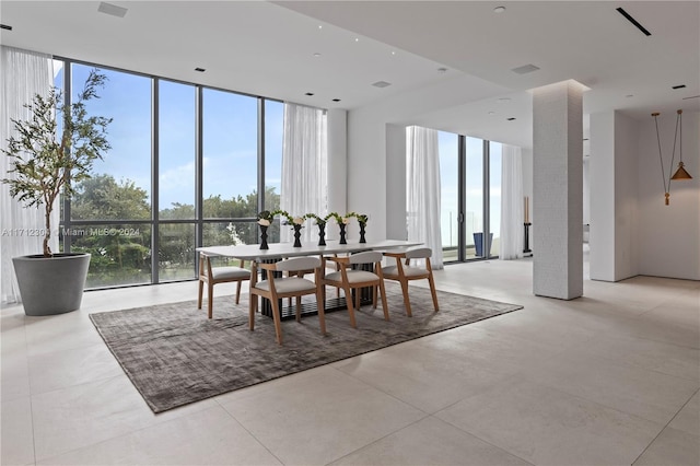 dining space featuring floor to ceiling windows