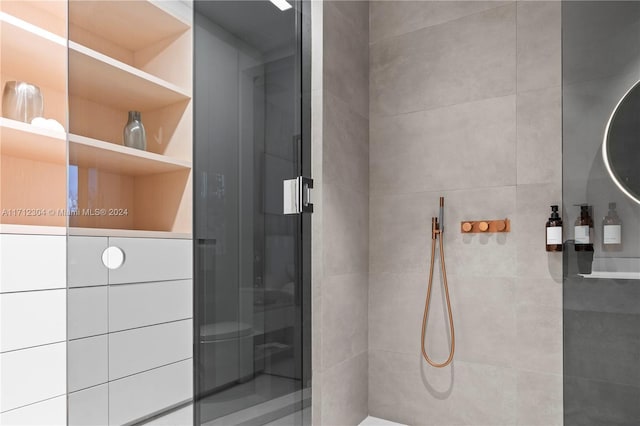 bathroom featuring a shower with door