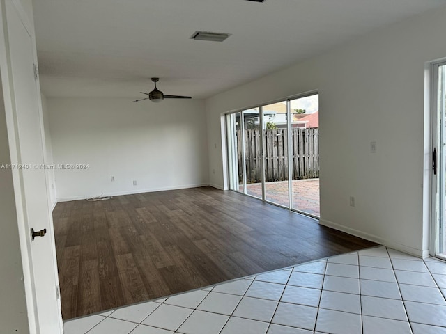 tiled spare room with ceiling fan