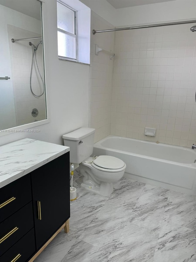 full bathroom with vanity, toilet, and tiled shower / bath