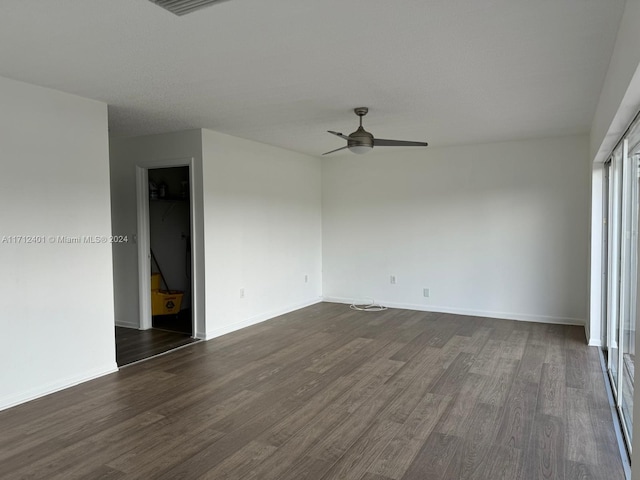 empty room featuring ceiling fan and dark hardwood / wood-style floors