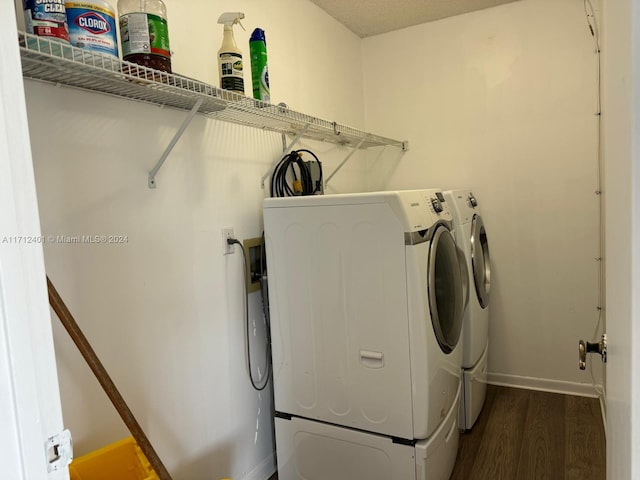 washroom with washing machine and dryer and dark wood-type flooring