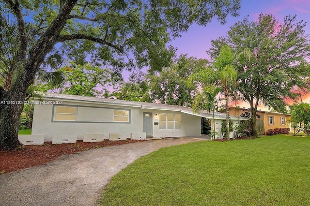 ranch-style house with a lawn