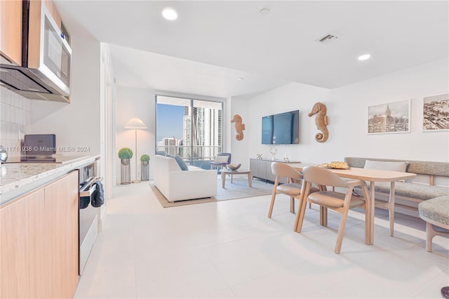 dining space with light tile patterned floors