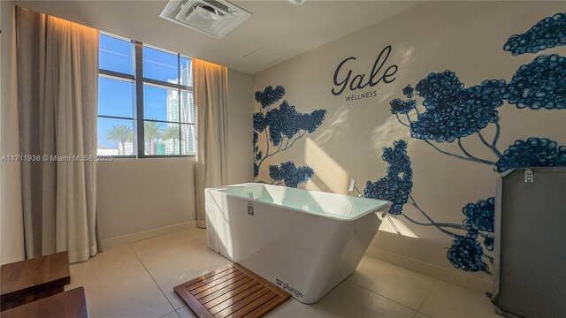 601 NE 1st Ave Unit 2409, Miami, FL 33132 - bathroom featuring tile patterned floors, baseboards, and a freestanding bath