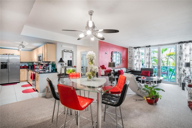 tiled dining area featuring ceiling fan