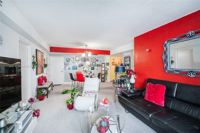 carpeted living room featuring ceiling fan and a textured ceiling