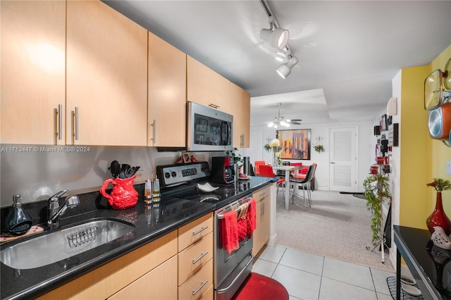 kitchen featuring light carpet, light brown cabinetry, stainless steel appliances, and sink