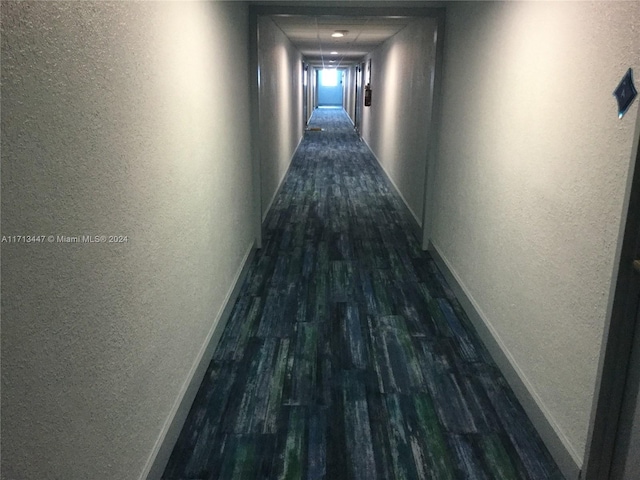 hallway with dark hardwood / wood-style flooring