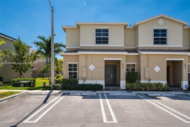495 NE 5th Ln, Florida City, FL 33034 - townhome / multi-family property with uncovered parking, stucco siding, and roof with shingles