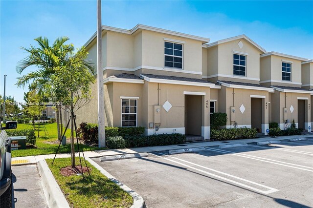 495 NE 5th Ln, Florida City, FL 33034 - townhome / multi-family property with stucco siding and uncovered parking