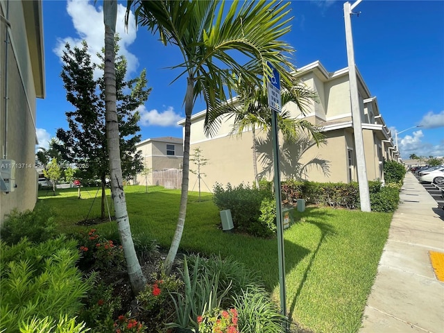 495 NE 5th Ln, Florida City, FL 33034 - view of property exterior featuring a yard and stucco siding