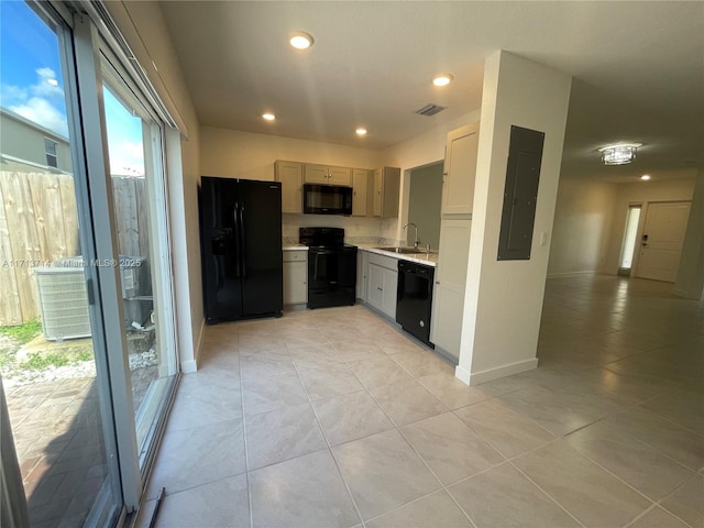 495 NE 5th Ln, Florida City, FL 33034 - kitchen featuring black appliances, light countertops, a sink, light tile patterned floors, and recessed lighting
