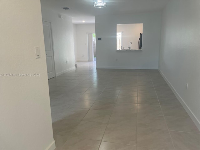 495 NE 5th Ln, Florida City, FL 33034 - tiled empty room with baseboards and a sink
