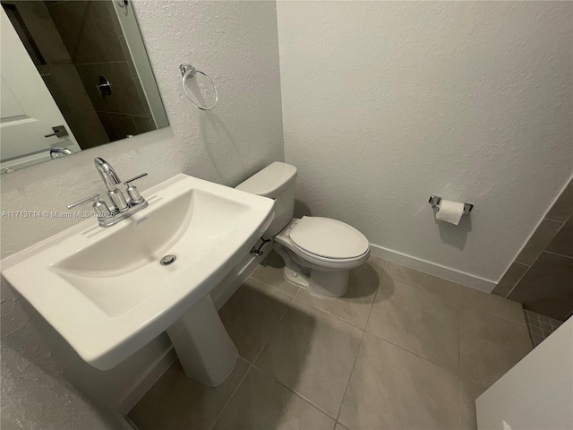 495 NE 5th Ln, Florida City, FL 33034 - bathroom featuring toilet, tile patterned floors, and a textured wall