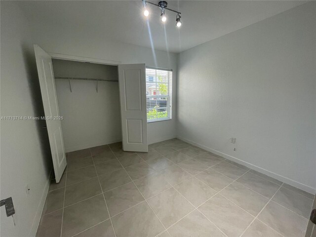 495 NE 5th Ln, Florida City, FL 33034 - unfurnished bedroom featuring light tile patterned floors and a closet