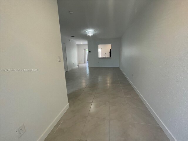 495 NE 5th Ln, Florida City, FL 33034 - corridor with light tile patterned floors and baseboards