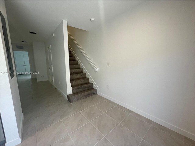 495 NE 5th Ln, Florida City, FL 33034 - stairway with tile patterned flooring and baseboards