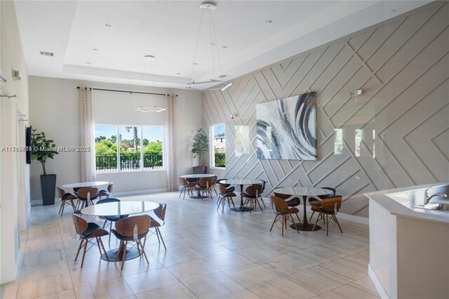 495 NE 5th Ln, Florida City, FL 33034 - dining area featuring a tray ceiling and wooden walls