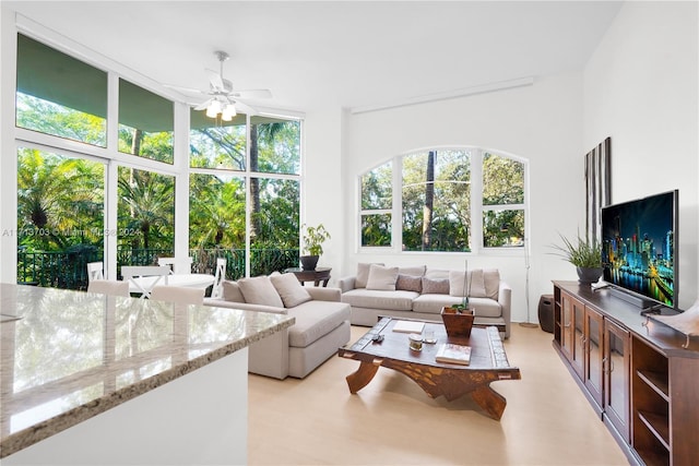 sunroom / solarium featuring ceiling fan