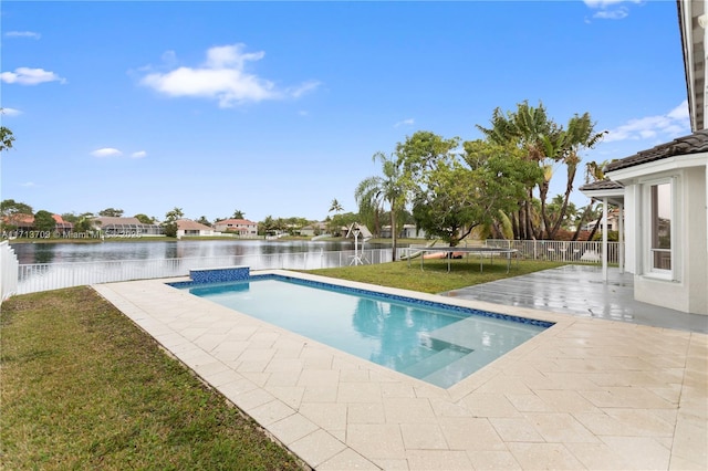 view of pool with a trampoline, a patio area, a water view, and a fenced backyard