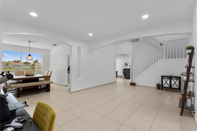 tiled dining room featuring a healthy amount of sunlight