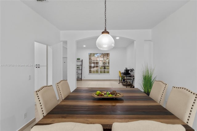 dining area featuring arched walkways