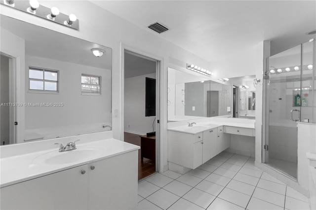 full bathroom with tile patterned flooring, a shower stall, two vanities, and a sink