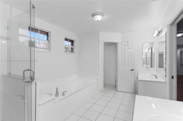 bathroom with vanity, a shower stall, a garden tub, and tile patterned floors