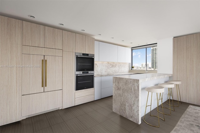 kitchen with white cabinetry, double oven, decorative backsplash, and kitchen peninsula