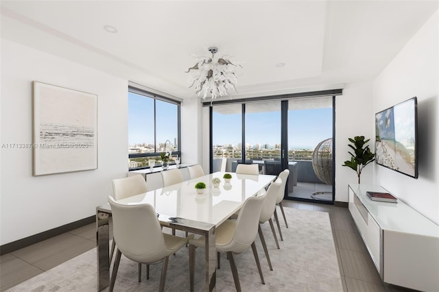 tiled dining room with an inviting chandelier and floor to ceiling windows