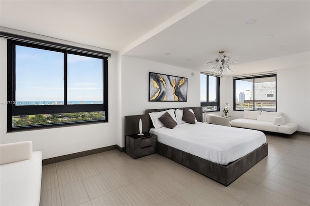 tiled bedroom with a chandelier