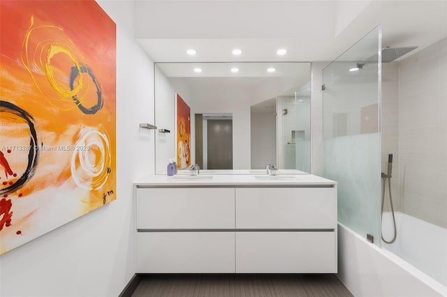 bathroom with vanity and tiled shower / bath