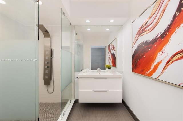 bathroom featuring vanity and a tile shower