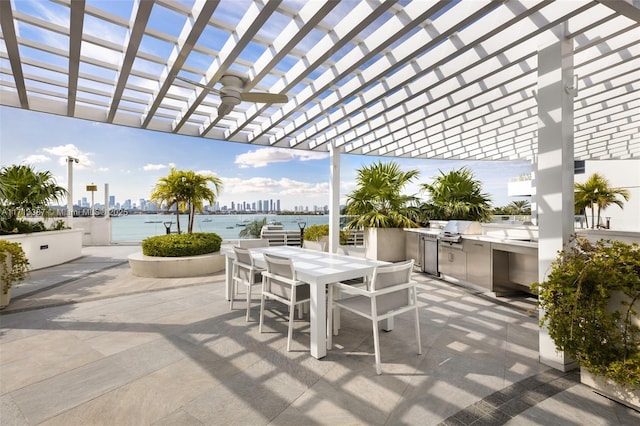 view of patio / terrace with a water view, grilling area, area for grilling, a pergola, and ceiling fan