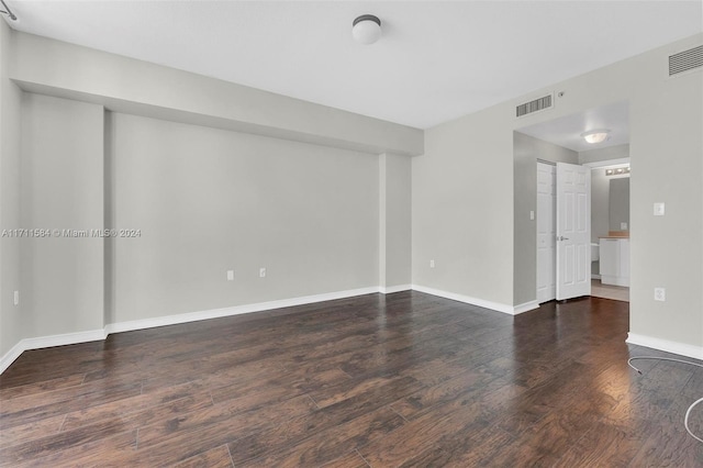 spare room featuring dark hardwood / wood-style flooring