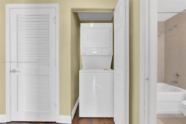 laundry room featuring stacked washer / drying machine